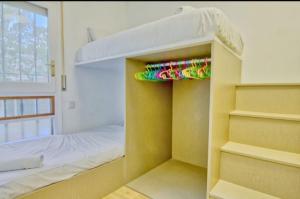 a bunk room with a bunk bed and a bunk bed at Casa Antoniet de la llum in Riumar