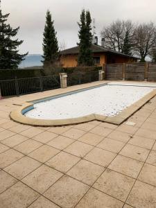 a swimming pool in the middle of a patio at Chez les Michel in Viry