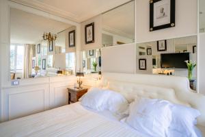a bedroom with a white bed and a mirror at Excelsior Palace Hotel in Rapallo