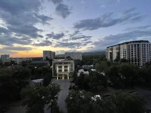 a view of a city with a building and trees at Апартаменты #3 in Almaty