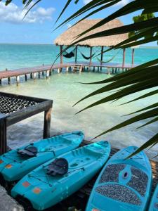 a group of blue kayaks sitting on the beach at Mi Kasa Tu Kasa Bacalar by Nah Hotels in Bacalar