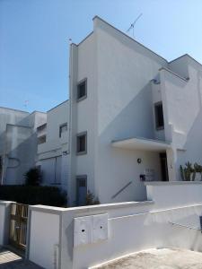a white building with a fence in front of it at Le Dimore di Otranto - Altomare in Otranto