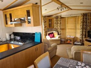 a kitchen and a living room with a counter top at 6 Berth central heated on The Chase Roxburgh FREE WIFI in Ingoldmells