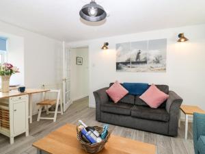 a living room with a couch and a table at Seaspray Cottage in Buckie