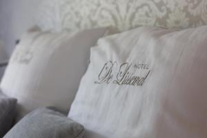 a pillow on a couch with a name on it at Hotel De Lissewal in Ieper