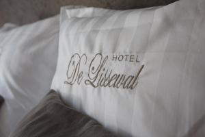 a white pillow with the words the hotel illustrated on it at Hotel De Lissewal in Ieper