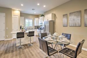 a kitchen and dining room with a table and chairs at Lovely Mesa Townhome with Pool and Hot Tub Access in Mesa