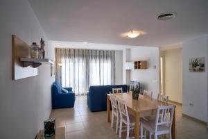 a dining room and living room with a table and chairs at Magnifico Apartamento Edificio Marina in Calafat