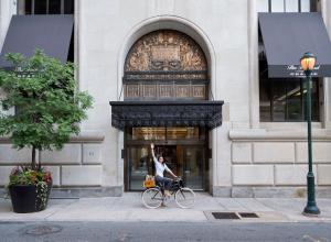 a person riding a horse in front of a brick building at ROOST Midtown in Philadelphia