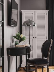 a desk with a chair and a book and a lamp at Maisons du Monde Hotel & Suites - Nantes in Nantes