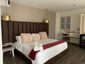 a bedroom with a large bed with two towels on it at Casa Martha hotel boutique in Tequisquiapan