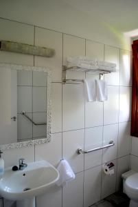 a bathroom with a sink and a mirror and a toilet at Casa Dos Barrancos C - Un Dormitorio, Parque Rural de Anaga in Santa Cruz de Tenerife