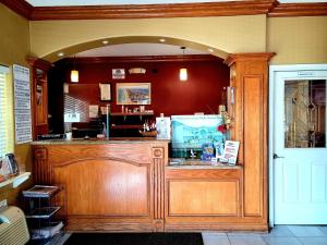 a restaurant with a counter in the middle of a room at Casa Bella Hotel and Suites in South Padre Island