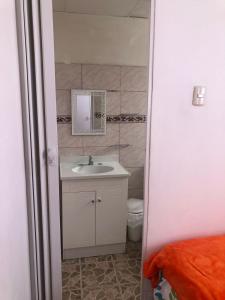 a bathroom with a sink and a toilet at Los Tamarindos Posadamanabita in Portoviejo