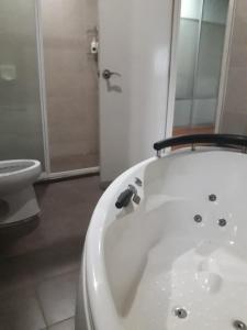 een badkamer met een wit bad en een toilet bij KLCC Putri YKS 7pax Kuala Lumpur in Kuala Lumpur
