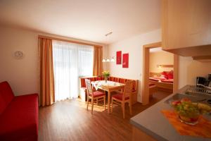 a kitchen and living room with a table and chairs at Appartements Bergblick in Flachau