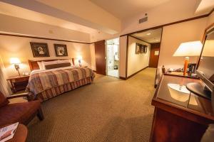 a hotel room with a bed and a bathroom at Alyeska Resort in Girdwood