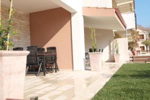 a patio with chairs and a table in a house at Villa Valerie in Nikiti