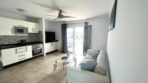 a living room with a couch and a table at Casa Zen, 1 bedroom apartment on complex with pool, Puerto del Carmen in Puerto del Carmen