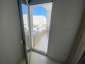 a sliding glass door with a view of a balcony at Cosy Apartment in La Marsa - 2 bed 1 Bath in La Marsa