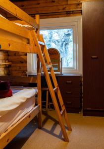 a bunk bed in a room with a desk and a ladder at Raasay in Kyle of Lochalsh