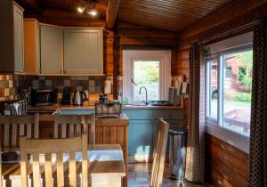 a kitchen with a table and chairs in a cabin at Raasay in Kyle of Lochalsh