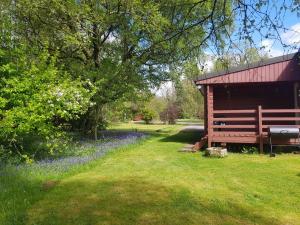 a bench in the grass next to a barn at Raasay in Kyle of Lochalsh