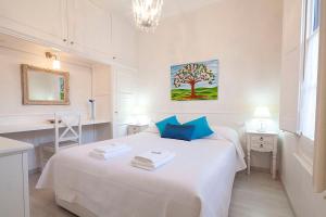 a bedroom with a white bed and a tree painting on the wall at Stay U-nique Apartments Gaudi II in Barcelona