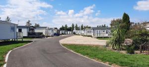 a road leading to a row of mobile homes at Royal Oak Caravan Park in Skegness