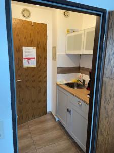 a door leading into a kitchen with a sink at App B210 gemütlich und ruhig in Lahnstein