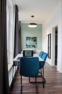 a dining room with a table with a laptop on it at HOMELY STAY Studio 6 in Munich