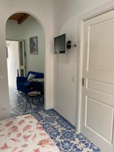 a bedroom with a bed and a door with a desk at TEA Isola Dino - HOTEL & HOME - Praia a Mare in Praia a Mare