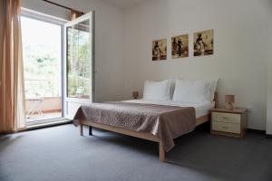 a bedroom with a bed and a large window at Villa Palma in Tučepi