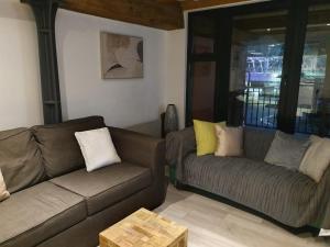 a living room with two couches and a table at SNG Apartments Excel in London