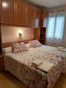 a bedroom with a large bed with a floral blanket at Xotola in Elizondo