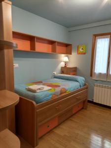 a bedroom with a bed with a wooden bed frame at Xotola in Elizondo