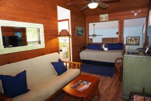 a bedroom with a bed and a couch in a room at Bandit's Hideaway-The Loft in Wimberley