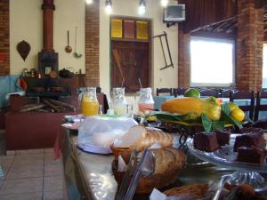 a table with a bunch of food on it at Pousada da Cachoeira in Monte Alegre do Sul