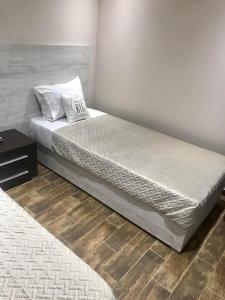 a bed in a bedroom with a white bedspread at Sabbia Beach House in Alykes