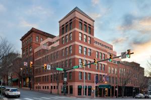 a large brick building on a city street with traffic lights at The Berkeley Hotel in Richmond