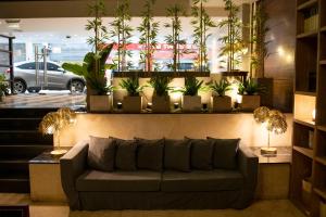 a living room with a couch and potted plants at Grand King Hotel in Buenos Aires