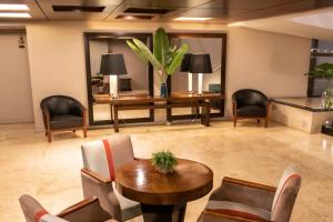 a lobby with chairs and a table and a desk at Grand King Hotel in Buenos Aires