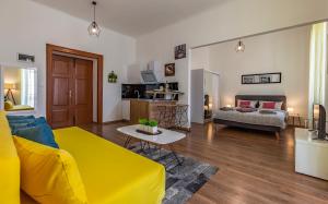 a living room with a yellow couch and a table at Apartment Dream Pula - City Centre in Pula