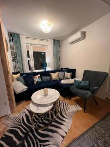 a living room with a couch and a zebra rug at Comfort Zone Ostróda Villa Apartment C in Ostróda