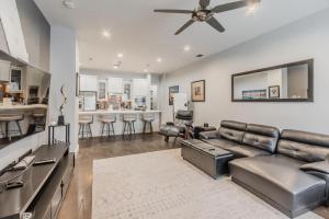 a living room with a couch and a bar at Stunning Townhome Near Uptown in Dallas