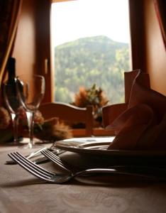 a table that has a knife and fork on it at Hotel Galeno in Auronzo di Cadore