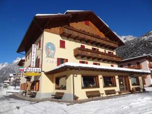 a large building with a ski lift on top of it at Hotel Galeno in Auronzo di Cadore