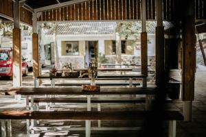 a row of wooden benches in front of a building at Glamping The Teepee in Mombeltrán
