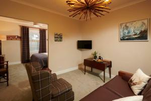 a living room with a couch and a bedroom at Downright Gabbler in Beauly