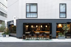 a restaurant with tables and chairs outside of a building at IMANO OSAKA SHINSAIBASHI HOSTEL - Vacation STAY 27589v in Osaka